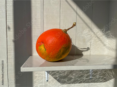a small ripe pumpkin on a balcony