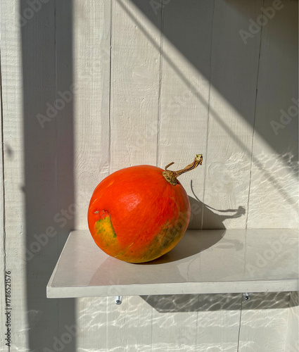 a small ripe pumpkin on a balcony
