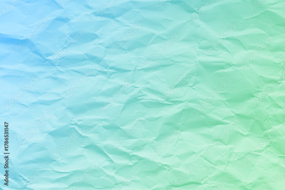 Obraz premium Crumpled turquoise green blue paper texture background. Wrinkled paper surface abstract background.