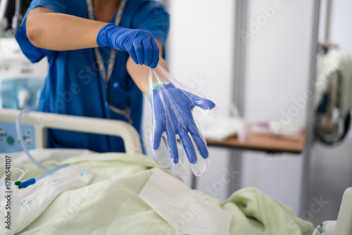 Nurse wearing protective gloves for patient care hygiene