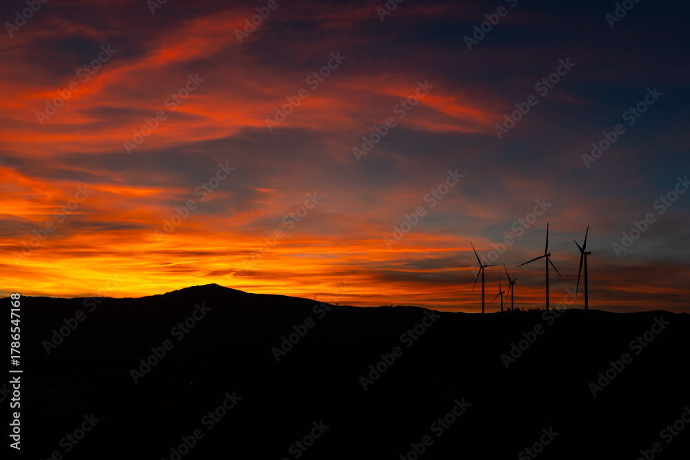 Fototapeta premium Dramatic Sunset Landscape with Wind Turbines Silhouette HDR