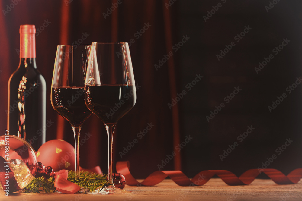 Fototapeta premium Christmas balls and wine on greeting card. Merry Christmas and Happy Holidays