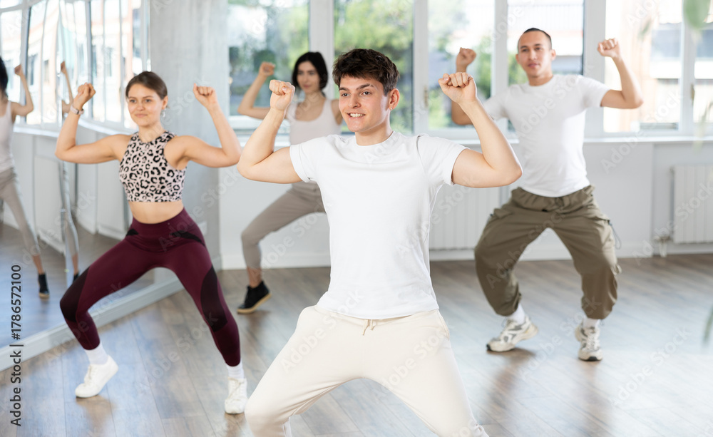 Naklejka premium Team of dancers performing contemporary dance in ball room