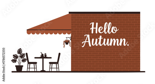 Cozy outdoor cafe seating with hello autumn text on a brick wall inviting fall season vibes