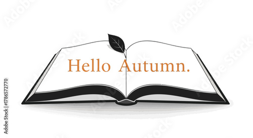 Open book with a feather and the words hello autumn written on the pages symbolizing the start of the fall season
