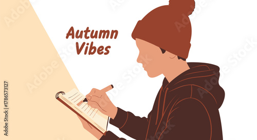 Young person wearing a beanie and hoodie writing in a journal with a pen in autumn season