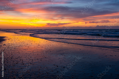 Colorful Stormy Morning Sky over Ocean and Beach