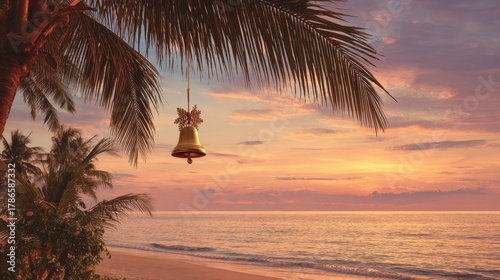 Fototapeta Naklejka Na Ścianę i Meble -  Golden Christmas bell hanging from coconut palm. Sunset beach background