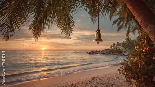 Fototapeta Naklejka Na Ścianę i Meble -  Golden Christmas bell hanging from coconut palm. Sunset beach background