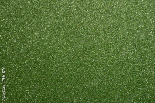 Bright green textured surface with fine glitter particles, ideal for creative projects or background design use