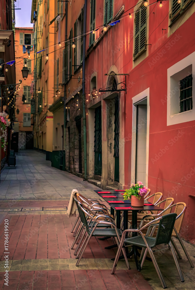 Fototapeta premium Al fresco tables waiting for customers at an outdoor restaurant in Nice, France