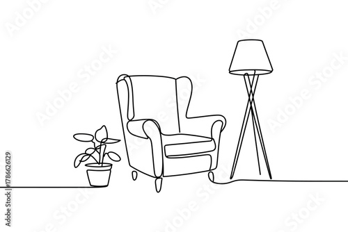 Cozy armchair and floor lamp create a minimalist reading nook with a potted plant.