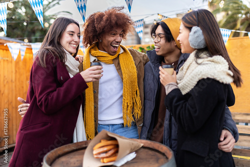 Canvas Print Multiracial young group of friends having fun together at christmas market on wi