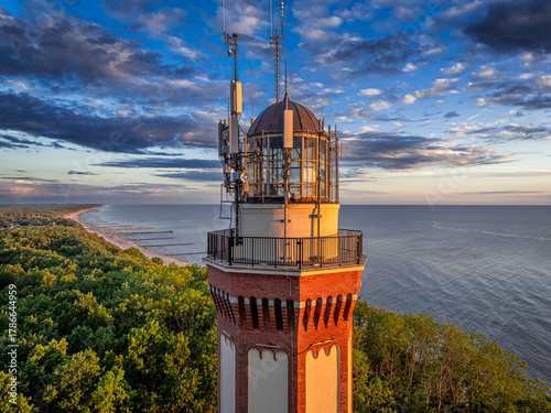 Fototapeta Naklejka Na Ścianę i Meble -  Unique coast and the lighthouse at sunset in Poland.
