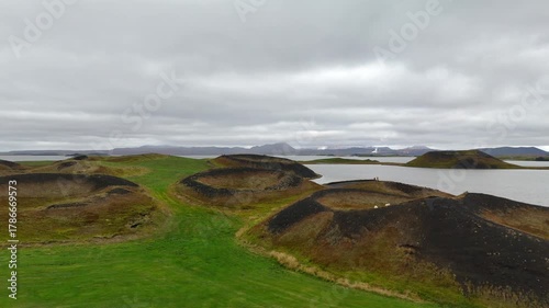 Panning 4K drone aerial footage over volcanic pseudo craters Skutustadagigar in lake Myvatn,Iceland.