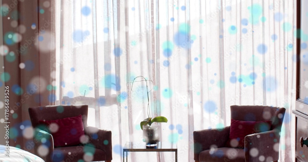 Fototapeta premium Displaying two dark armchairs sitting facing inward in hotel suite sitting area, with potted orchid