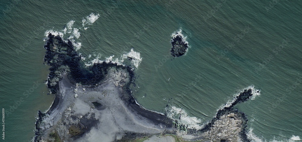 Obraz premium Volcanic Rocky Headland Aerial View Iceland Islet Coast