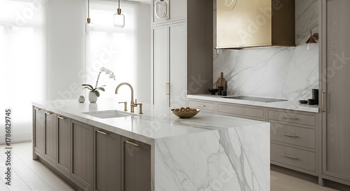 Luxurious contemporary kitchen interior showcasing a spacious white marble island, elegant taupe cabinetry, and stylish gold fixtures, defining modern home design