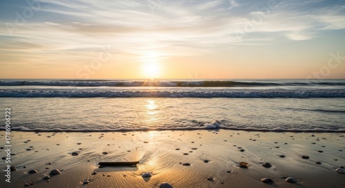 Golden Sunset Over Ocean Waves and Sandy Beach.