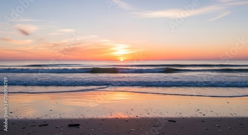 Golden Sunset Over Ocean Waves on a Sandy Beach.
