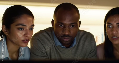 Three colleagues discussing project details in office