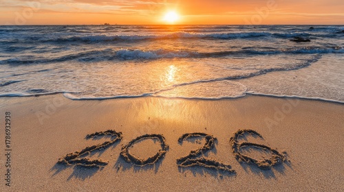 Happy New Year 2026 concept, lettering on the beach. Written text on the sea beach at sunrise.