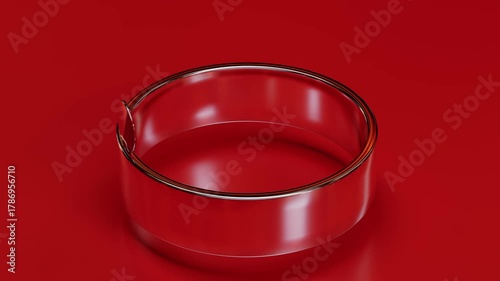 Cylinder glass turning on a ring isolated on a red background 3D computer generated animation loop