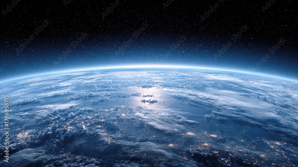 Fototapeta premium The Earth's horizon with a blue sky and illuminated cities below.