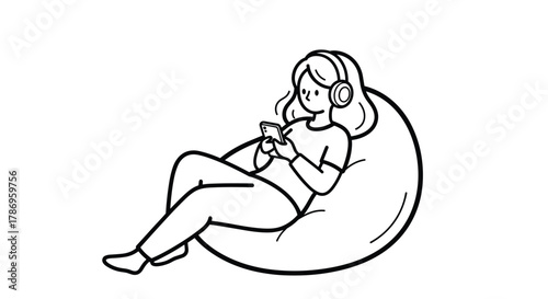 Young woman relaxes on beanbag listening to music on headphones while scrolling on her phone for entertainment