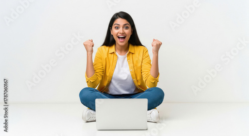 Excited Young Woman Celebrating Success While Using Laptop