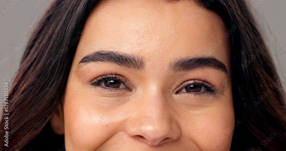 Obraz premium Portrait, woman and eyes in studio with microblading, eyelash extension and skincare for beauty. Female person, lash lift and eyebrow transformation for makeup aesthetic, wellness and dermatology.