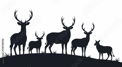 Majestic deer family silhouettes standing together on a natural hill.