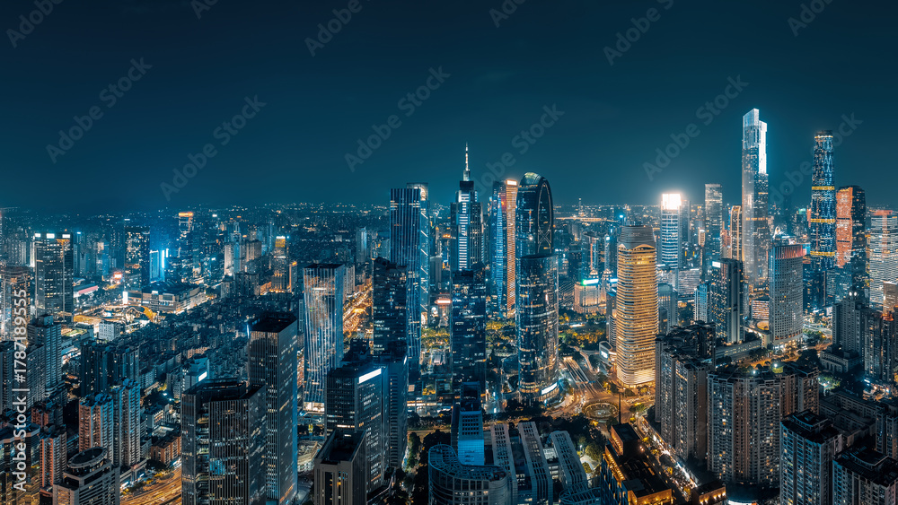 Obraz premium Aerial view of the glowing skyscrapers and modern architecture in the financial district of a major city at night in Guangzhou.