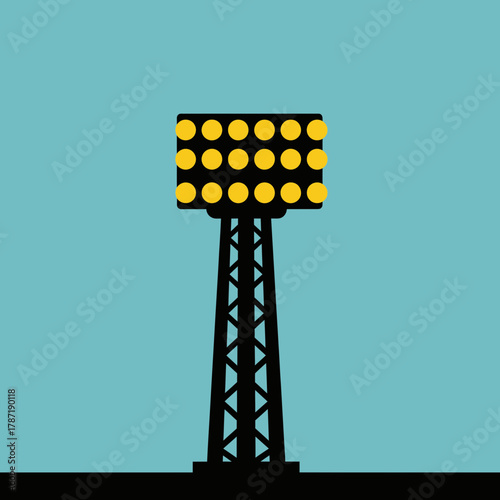 Tall tower with bright lights against a blue sky.