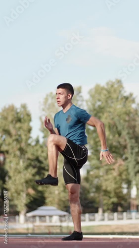 runner man standing on stadium after workout vertical slow motion fullHD calm focus discipline reflection strength inner peace morning light motivation balance confidence
