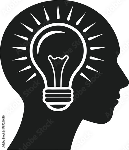 Silhouette of a human head with a glowing lightbulb inside representing creative thinking