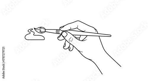 an artist s hand delicately holding a paintbrush near a small palette