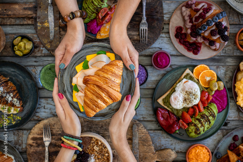 Croissant sandwich filled with ham, bacon, cheese and salad.  croisandwich