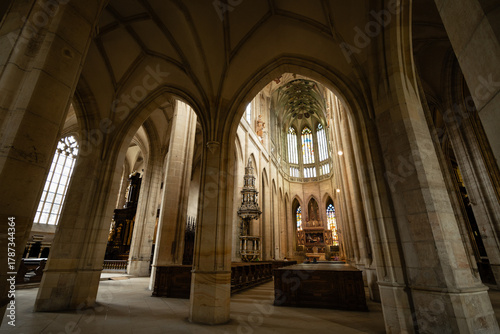 Kutná Hora, Czech Republic – August 8, 2025: Side aisle view of St. Barbara’s Cathedral with Gothic arches framing the ornate Baroque altar and chancel in Kutná Hora
