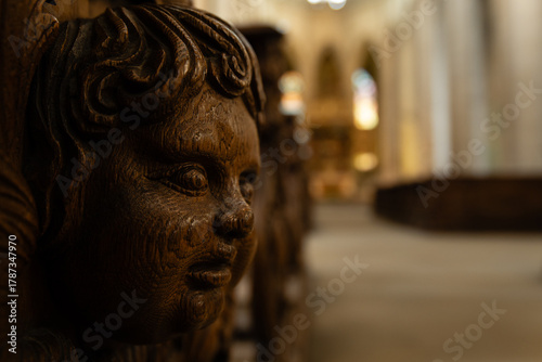 Kutná Hora, Czech Republic – August 8, 2025: Detailed wood carving of face on historic church pew inside Cathedral of St. Barbara, Kutná Hora, UNESCO World Heritage Site