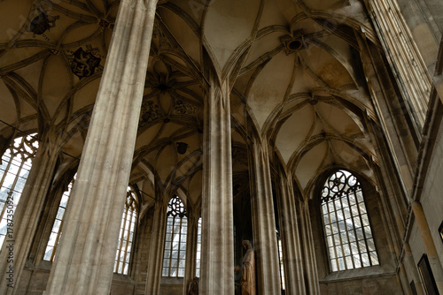 Kutná Hora, Czech Republic – August 8, 2025: Upper triforium gallery view of Gothic vaulted ceilings and exterior flying buttress support system visible through windows, Cathedral of St. Barbara