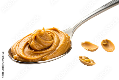 Spoonful of creamy peanut butter with whole peanuts