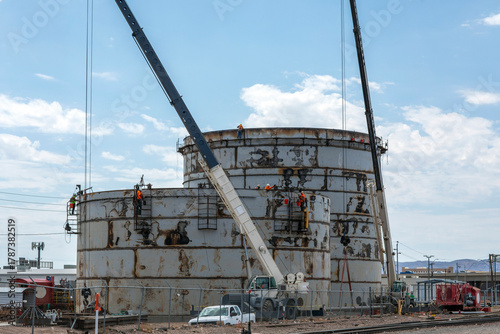 Photography Steel storage tanks being constructed with cranes
