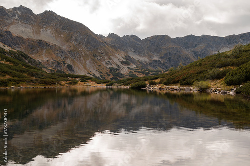 Fototapeta Naklejka Na Ścianę i Meble -  Mountain Lake with Reflections and Rugged Peaks