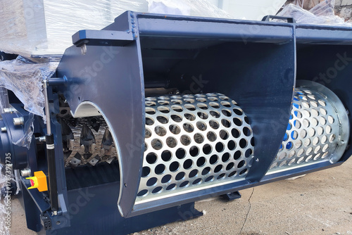 Single-shaft mechanical industrial shredder. Equipment for shredding and recycling waste.