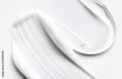 samples of cosmetic care products smear of cream and gel texture on a light background