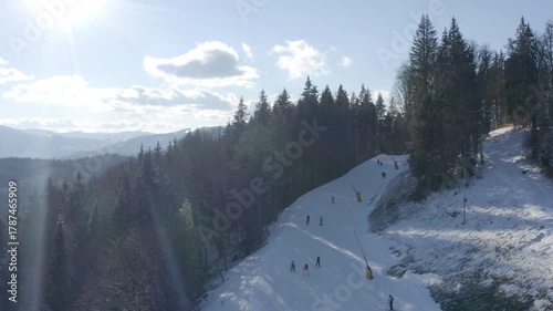 Skiing on snowy slopes in the mountains during a sunny winter day