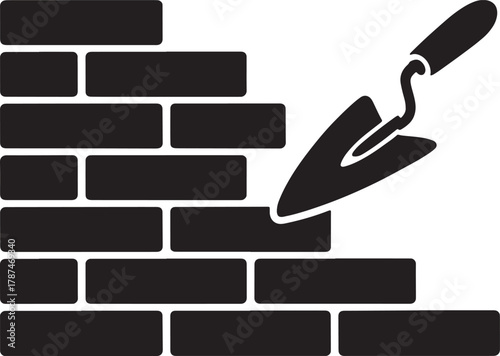 Bricklaying wall construction process with trowel used by bricklayer in building