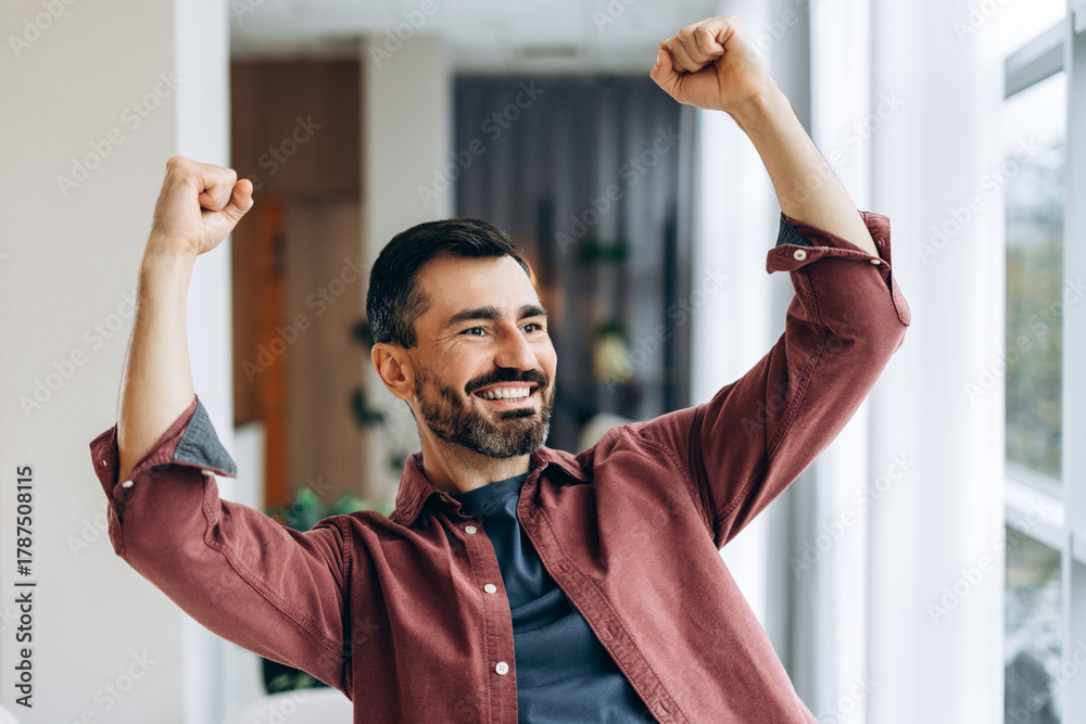 Naklejka premium Happy man celebrating success achieving victory
