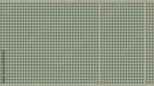 A close up view of a pegboard with evenly spaced holes creating a uniform and repetitive pattern design
